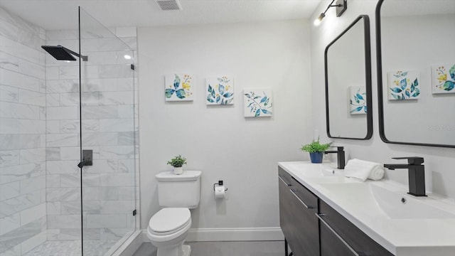 bathroom with toilet, vanity, and walk in shower