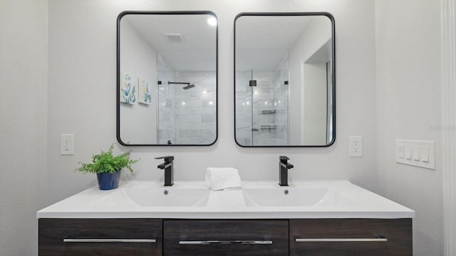 bathroom featuring vanity and tiled shower