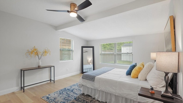 bedroom featuring lofted ceiling with beams, light hardwood / wood-style flooring, and ceiling fan