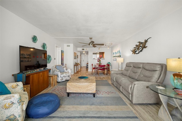 living room with ceiling fan and hardwood / wood-style floors