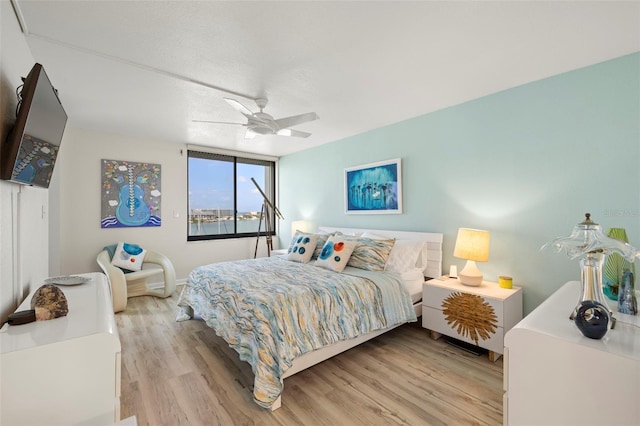 bedroom featuring ceiling fan and light hardwood / wood-style flooring