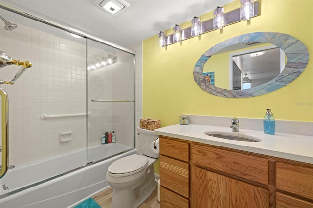 full bathroom with toilet, shower / bath combination with glass door, visible vents, and vanity