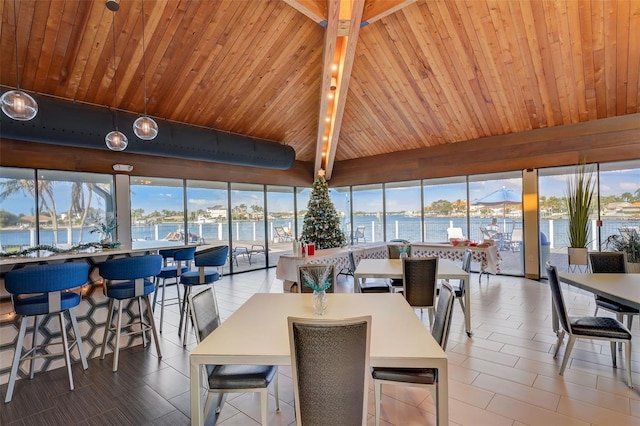 tiled dining room with beam ceiling, wood ceiling, and a water view