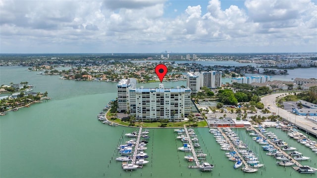 birds eye view of property with a view of city and a water view