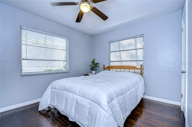 bedroom with ceiling fan and dark hardwood / wood-style floors