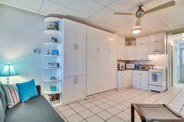 kitchen with ceiling fan, white cabinetry, light tile patterned flooring, and white appliances