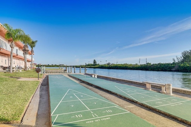 surrounding community featuring a lawn and a water view