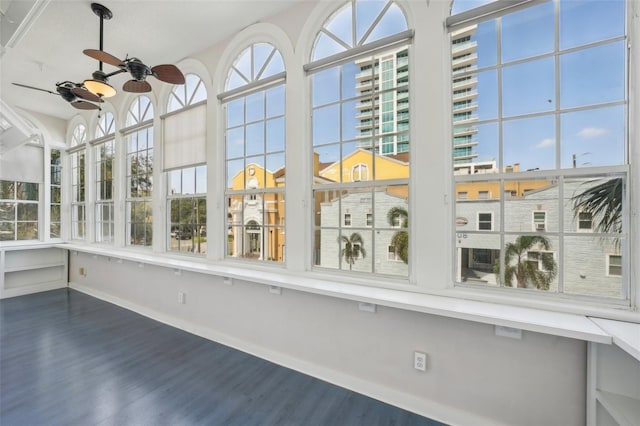 unfurnished sunroom featuring ceiling fan