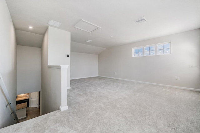 carpeted empty room with lofted ceiling