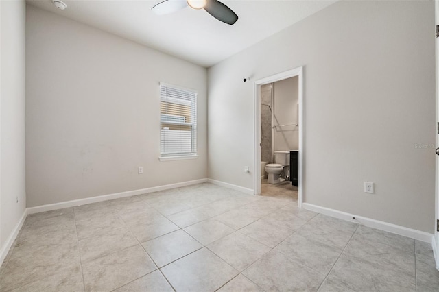 spare room with ceiling fan and light tile patterned flooring