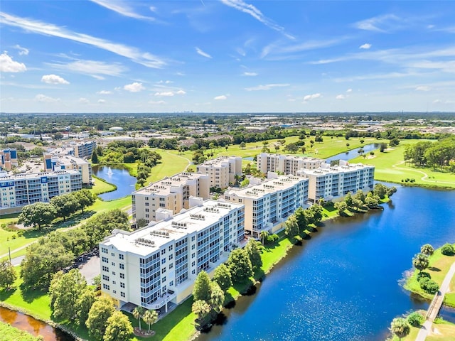 bird's eye view featuring a water view, view of golf course, and a city view