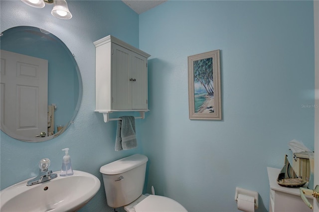 bathroom with toilet and a sink