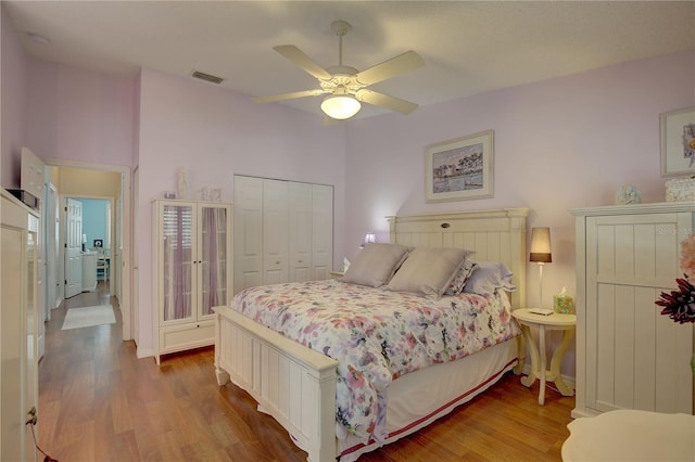 bedroom featuring light wood-type flooring, a closet, and ceiling fan