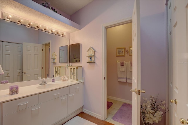 bathroom featuring tile patterned flooring and vanity