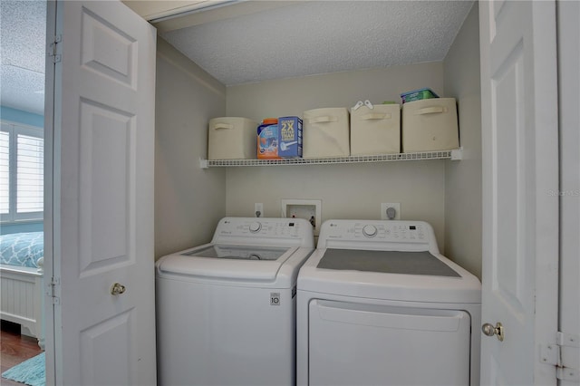 laundry area with washer and dryer and a textured ceiling