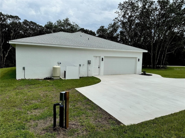 view of side of home featuring a garage and a yard