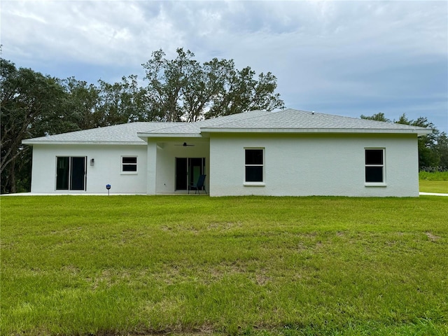 back of house featuring a lawn