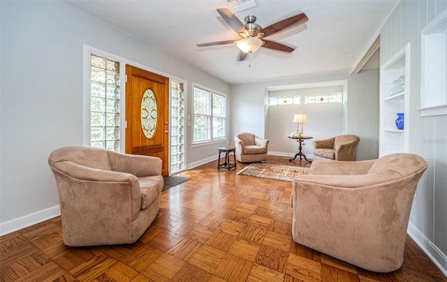 living room featuring ceiling fan and parquet flooring