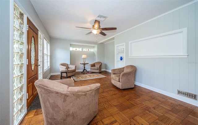 living room with ceiling fan and parquet floors