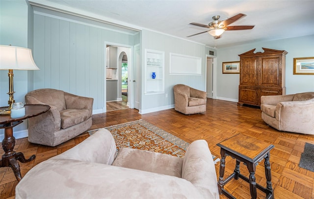 living room with ceiling fan and parquet flooring