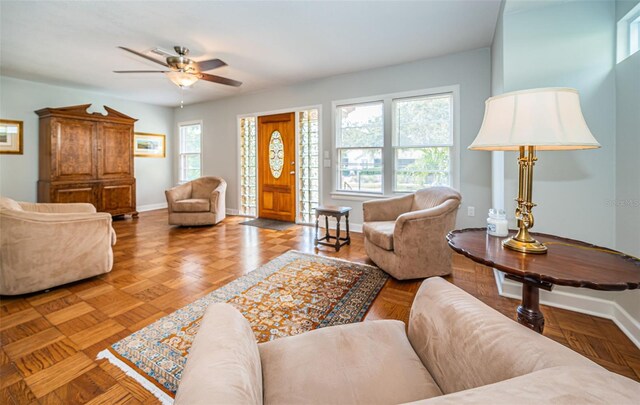 living room with ceiling fan and light parquet floors