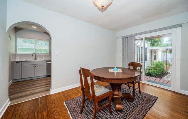 dining area featuring hardwood / wood-style floors and sink