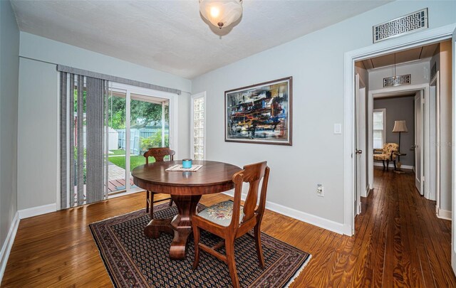 dining space with hardwood / wood-style floors