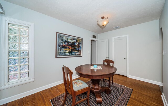 dining room with dark hardwood / wood-style floors