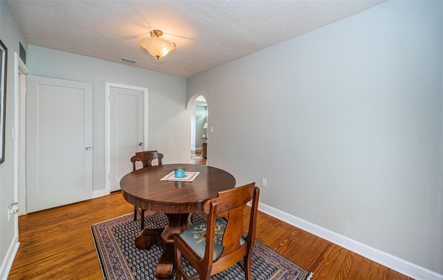 dining space with hardwood / wood-style flooring