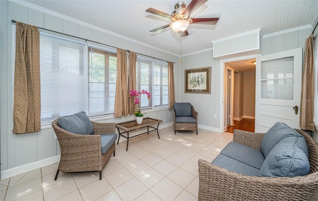 living room featuring ceiling fan, ornamental molding, and light tile patterned floors