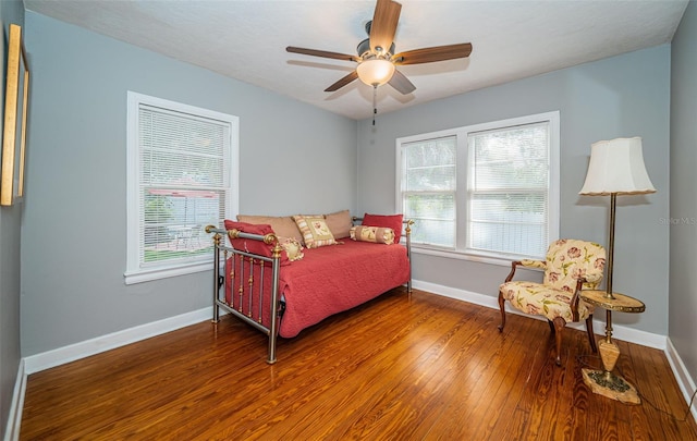 bedroom with ceiling fan, wood finished floors, and baseboards