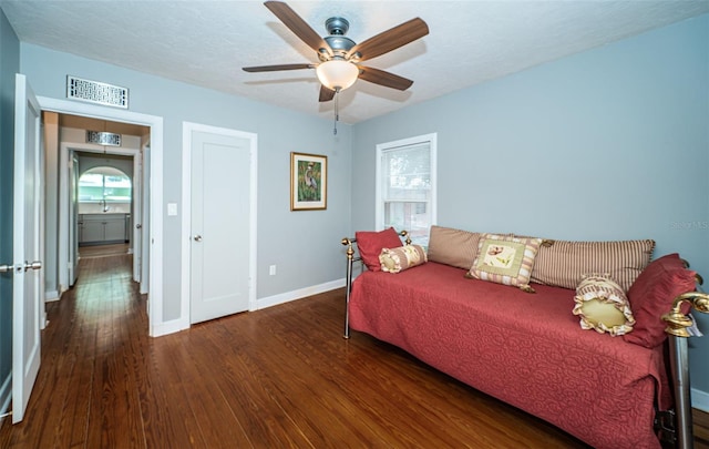 living room featuring ceiling fan, a wealth of natural light, and hardwood / wood-style flooring