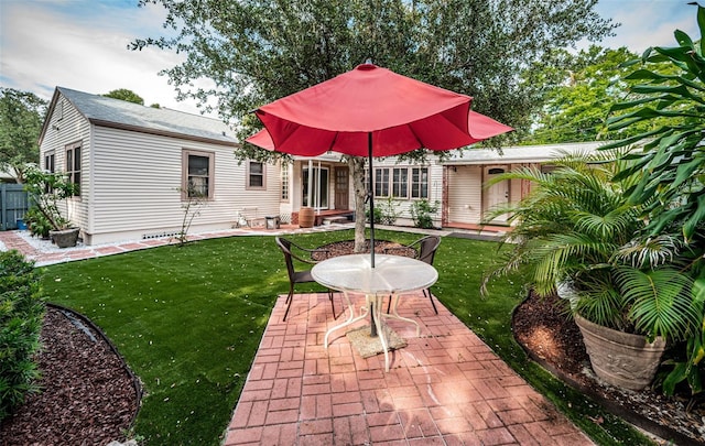 back of house with a patio, a lawn, and fence