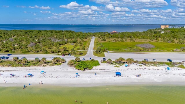 bird's eye view featuring a water view and a view of the beach