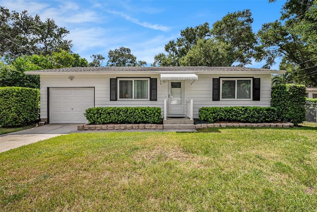 ranch-style home featuring a garage and a front lawn