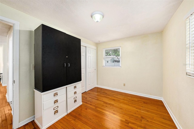 unfurnished bedroom featuring a closet and light wood-type flooring