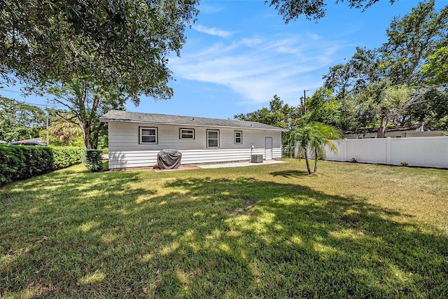 rear view of property with a yard