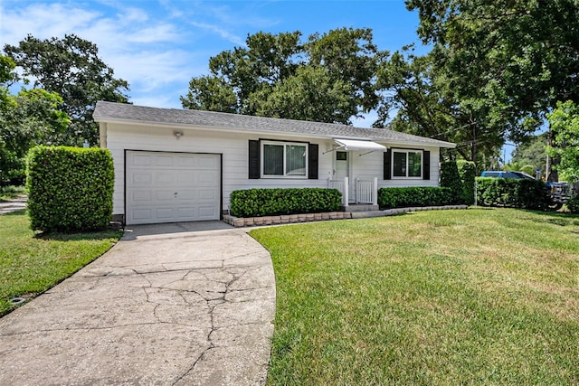 ranch-style house with a garage and a front lawn