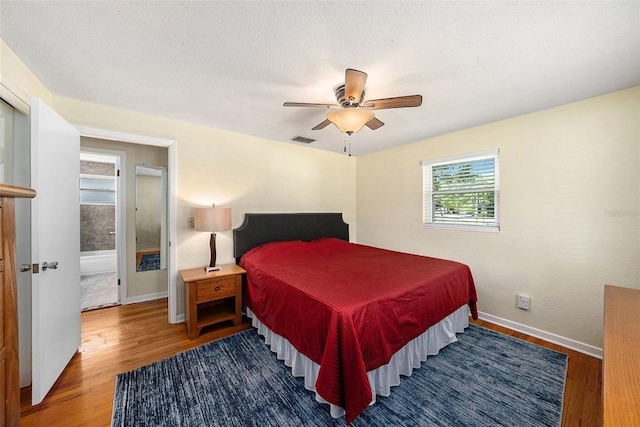 bedroom featuring hardwood / wood-style flooring, a textured ceiling, and ceiling fan