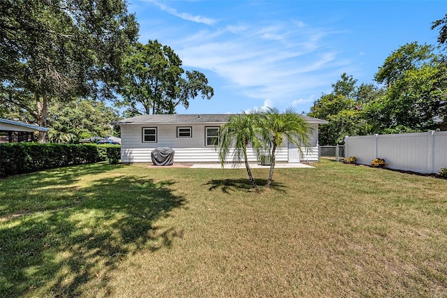 back of house with a yard