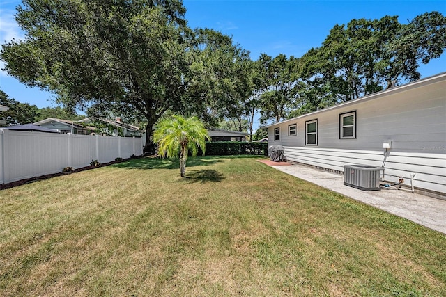 view of yard featuring central AC unit and a patio area