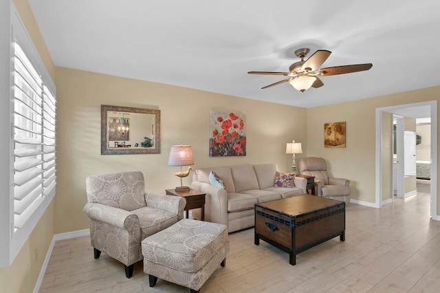 living room featuring ceiling fan and light hardwood / wood-style flooring