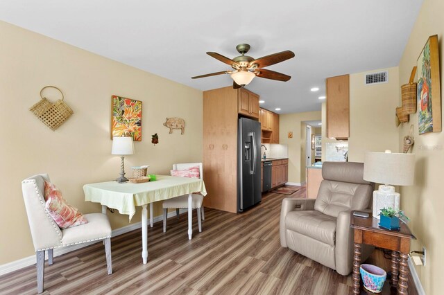 dining area with ceiling fan and hardwood / wood-style floors