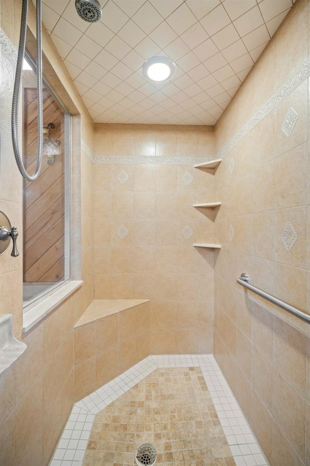 bathroom with a tile shower