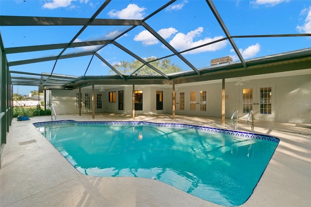 view of pool with glass enclosure, ceiling fan, french doors, and a patio