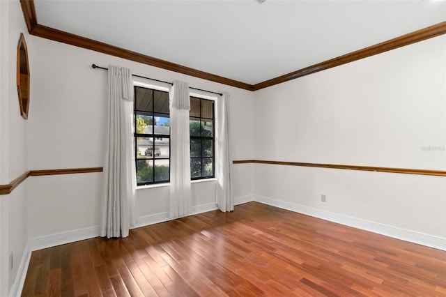 spare room with hardwood / wood-style floors and ornamental molding