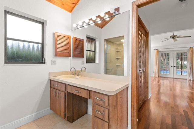 bathroom featuring ceiling fan, french doors, vaulted ceiling, vanity, and hardwood / wood-style flooring