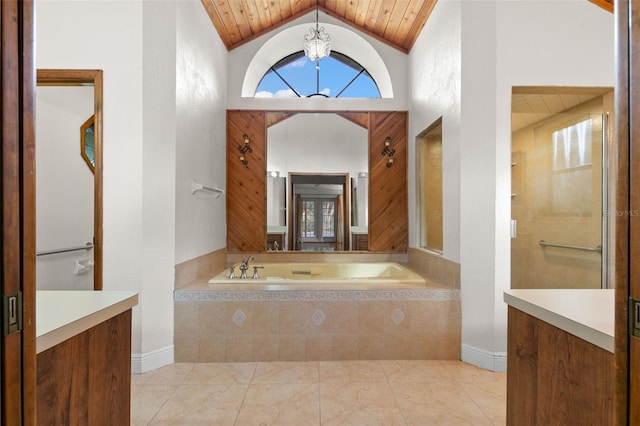 bathroom featuring vanity, a relaxing tiled tub, an inviting chandelier, and wooden ceiling