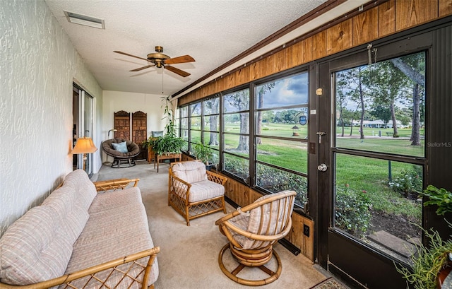 sunroom / solarium featuring ceiling fan