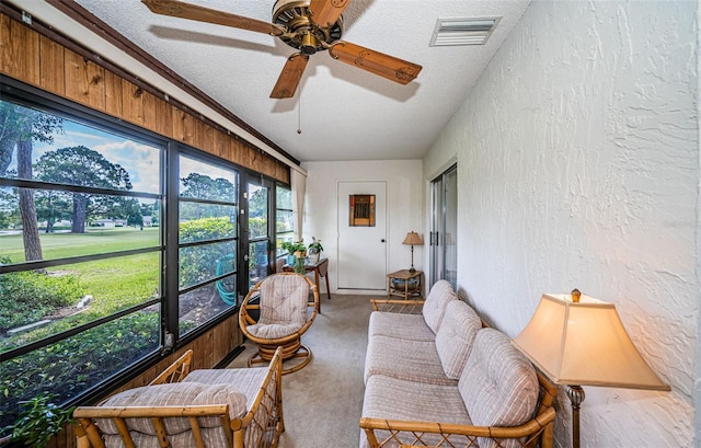 sunroom / solarium featuring ceiling fan